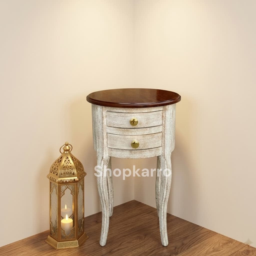  Bliss Antique Wooden Table top-down view of round dark antique stained tabletop, Pakistan Bliss Antique Wooden Table as sofa side table in luxury Pakistani living room with lamp and flowers, Pakistan Bliss Antique Wooden Table as bedside nightstand in cozy Pakistani bedroom with table lamp, Pakistan Bliss Antique Wooden Table placed in corner of Pakistani drawing room with gold lantern, Pakistan Bliss Antique Wooden Table beside armchair in Pakistani reading nook with books and candle, Pakistan Bliss Antique Wooden Table front view showing two drawers brass knobs and curved antique legs, Pakistan Copy karke website ke image alt text field mein paste karo — ek image ka ek alt text! ✅ 😊
